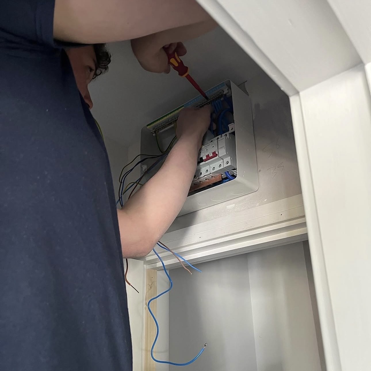Electrician completing consumer unit work